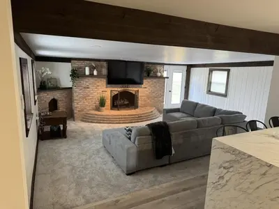 a living room with a couch and a fireplace at Farm Views - 10 min to Sight & Sound in Ronks