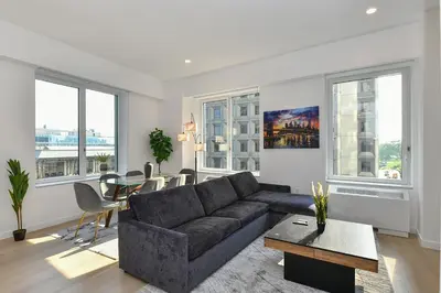 a living room with a couch and a table at Contemporary Luxury 3BR 2BA Downtown NYC in New York