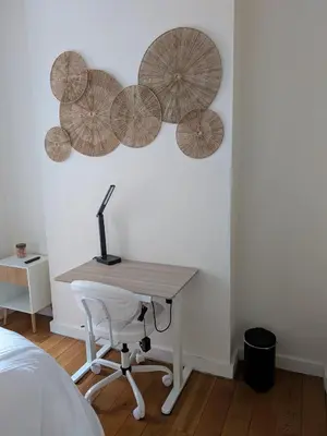 a bedroom with a desk and four umbrellas on the wall at The Midtown Sanctuary - Private Silent Suite at Times Square in New York