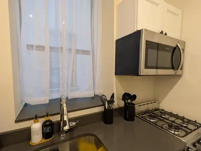 a kitchen with a sink and a microwave at The Midtown Sanctuary - Private Silent Suite at Times Square in New York
