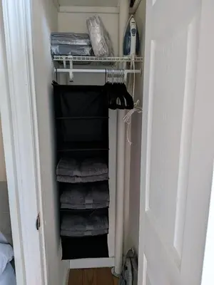 a closet with a rack of towels and towels at The Midtown Sanctuary - Private Silent Suite at Times Square in New York