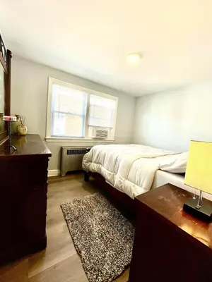 a bedroom with a bed and a desk and a window at Very cozy 3 bedroom house close to everything in Chester
