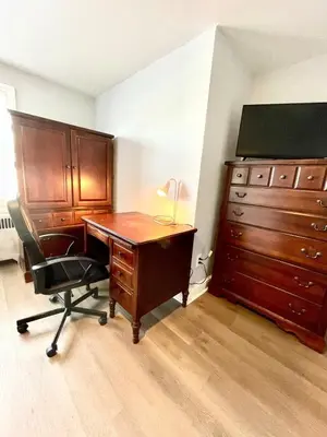an office with a wooden desk and a dresser at Very cozy 3 bedroom house close to everything in Chester