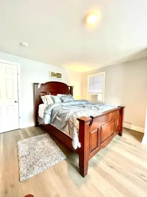 a bedroom with a large wooden bed in a room at Very cozy 3 bedroom house close to everything in Chester