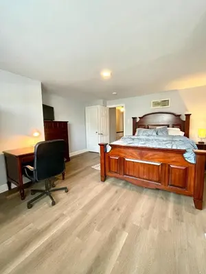 a bedroom with a bed and a desk and a chair at Very cozy 3 bedroom house close to everything in Chester