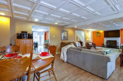 a living room with a couch and a table at Mtn-View Balcony! All-Season Apt Near Jim Thorpe in Nesquehoning