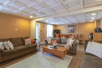 a living room with couches and a coffee table at Mtn-View Balcony! All-Season Apt Near Jim Thorpe in Nesquehoning