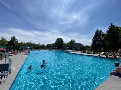 a group of people in a large swimming pool at Pocono Ski Home Fire Pit Game Room EV in Tobyhanna