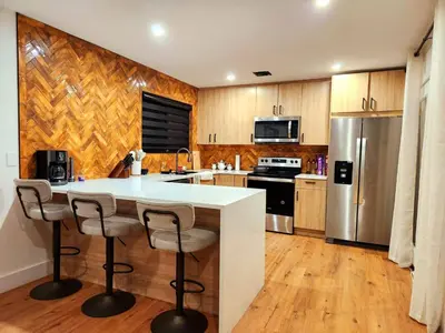 a kitchen with a white counter and a refrigerator at Pocono Ski Home Fire Pit Game Room EV in Tobyhanna