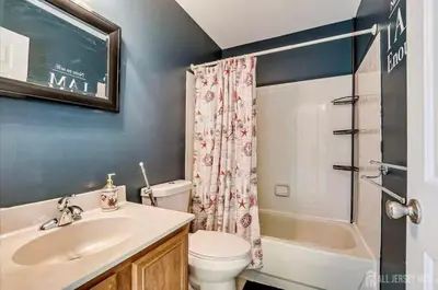 a bathroom with a sink and a toilet and a shower at Comfortable Private Room with Bath Easy Transit in Piscataway