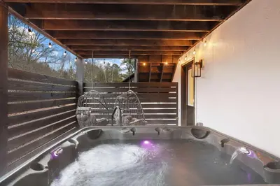 a jacuzzi tub in the backyard of a house at Moon Mtn Manor Sleeps 16 Karaoke Hot Tub in Albrightsville