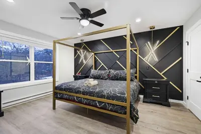 a bedroom with a canopy bed and a ceiling fan at Moon Mtn Manor Sleeps 16 Karaoke Hot Tub in Albrightsville