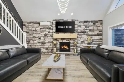 a living room with a couch and a fireplace at Moon Mtn Manor Sleeps 16 Karaoke Hot Tub in Albrightsville