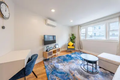 a living room with a couch and a table at Modern 2BR 8 mins to Penn Station with WiFi Laundry in Newark