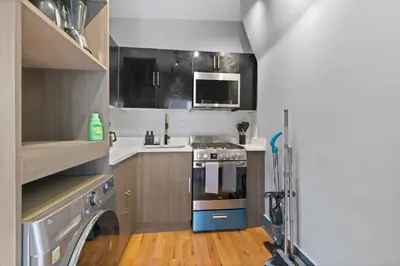 a small kitchen with a stove and a microwave at Modern & Cozy Studio in Jersey 20 Min to New York in Jersey City