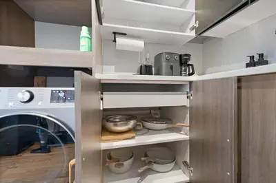 a kitchen with a washing machine and some dishes at Modern & Cozy Studio in Jersey 20 Min to New York in Jersey City
