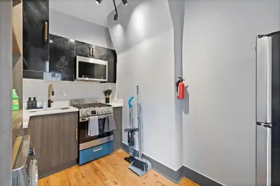 a kitchen with a stove and a refrigerator at Modern & Cozy Studio in Jersey 20 Min to New York in Jersey City
