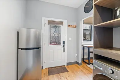 a kitchen with a stainless steel refrigerator and a window at Modern & Cozy Studio in Jersey 20 Min to New York in Jersey City