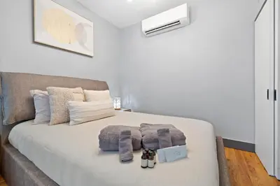 a bedroom with a bed with blankets and pillows at Modern & Cozy Studio in Jersey 20 Min to New York in Jersey City