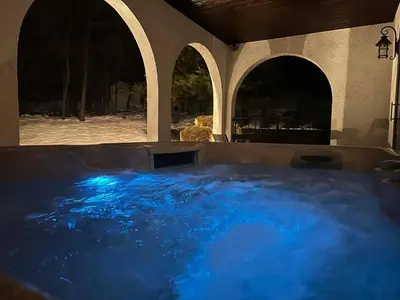 a hot tub with blue water in a building at Mediterranean villa hot tub fire place•fire pit in Monroe