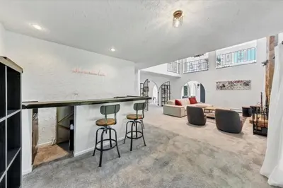 a kitchen and living room with a bar and stools at Mediterranean villa hot tub fire place•fire pit in Monroe