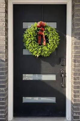 a black front door with a wreath on it at The Signature Modern Flat in Newark