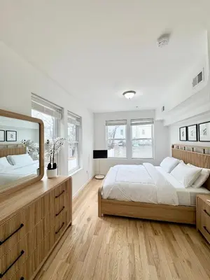 a bedroom with two beds and a large mirror at The Signature Modern Flat in Newark