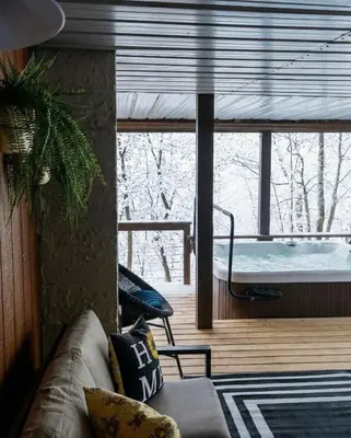a living room with a couch and a hot tub at NEW! Montview Chalet - Hot Tub, Sauna, EV, Views in East Stroudsburg