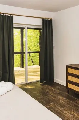 a bedroom with a bed and a sliding glass door at NEW! Montview Chalet - Hot Tub, Sauna, EV, Views in East Stroudsburg