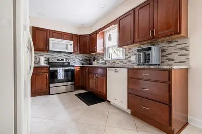 a kitchen with wooden cabinets and appliances at 5 Woods Dr in Mechanicsburg