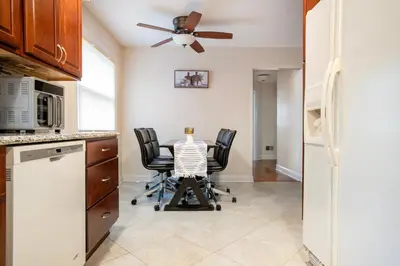 a kitchen with a table with chairs and a ceiling fan at 5 Woods Dr in Mechanicsburg