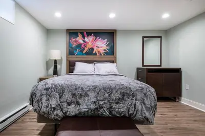 a bedroom with a bed and a painting on the wall at 5 Woods Dr in Mechanicsburg