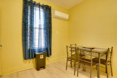 a dining room with a table and a window at Easy City Commuting! Walkable Newark Duplex in Newark