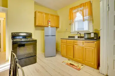 a kitchen with a refrigerator and a stove in it at Easy City Commuting! Walkable Newark Duplex in Newark