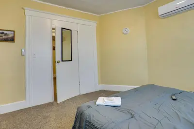 a bedroom with a bed with a towel on it at Easy City Commuting! Walkable Newark Duplex in Newark