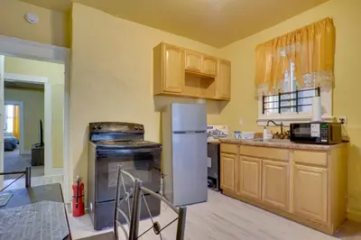 a kitchen with wooden cabinets and a refrigerator at 2 Mi to Rutgers University! Urban Hub Near Parks in Newark