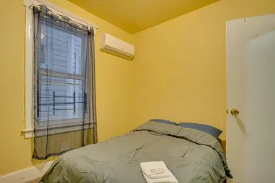 a small bedroom with a bed and a window at 2 Mi to Rutgers University! Urban Hub Near Parks in Newark