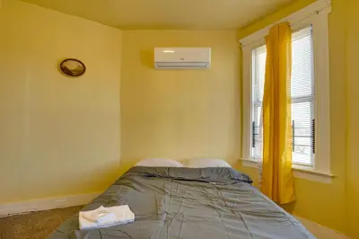 a bedroom with a bed and a window at 2 Mi to Rutgers University! Urban Hub Near Parks in Newark