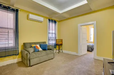 a living room with a couch and a window at 2 Mi to Rutgers University! Urban Hub Near Parks in Newark
