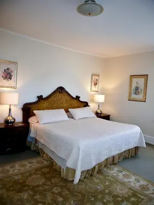 a bedroom with a large bed with two lamps at Turkey Hill Inn in Summit