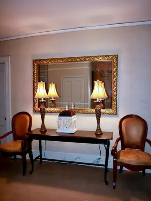a room with a table with two chairs and a mirror at Turkey Hill Inn in Summit
