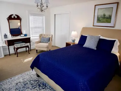 a bedroom with a blue bed and a chair and a desk at Turkey Hill Inn in Summit