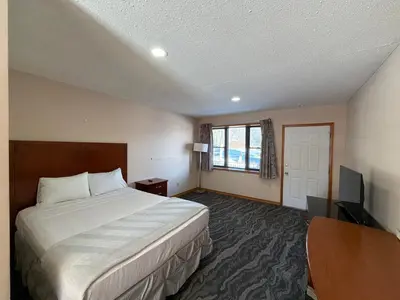 a hotel room with a bed and a television at Skyline Inn in Mount Pocono