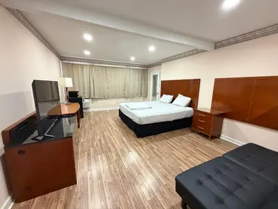 a hotel room with a bed and a television at Skyline Inn in Mount Pocono