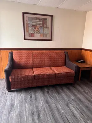 a couch in a waiting room in a hospital at Coachman Motor Lodge in Elmira
