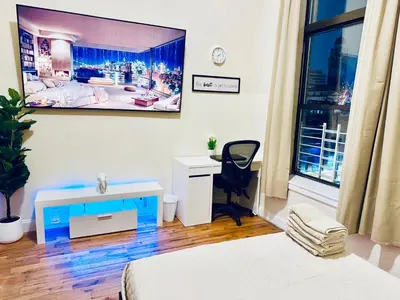 a room with a bed and a desk and a window at Ultra-Modern Luxury Room Executive Stay Near NYC in Paterson