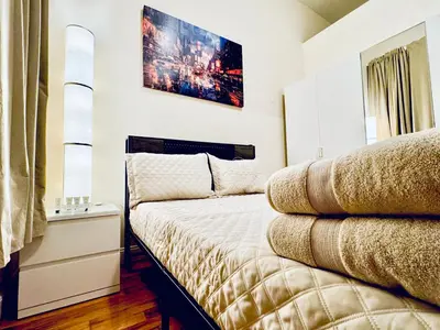 a bedroom with a bed and a picture on the wall at Ultra-Modern Luxury Room Executive Stay Near NYC in Paterson