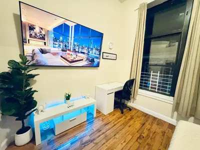 a room with a desk and a large picture on the wall at Ultra-Modern Luxury Room Executive Stay Near NYC in Paterson
