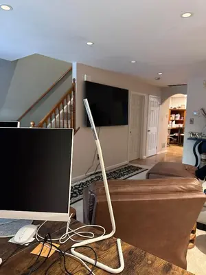 a computer monitor on a table in a living room at Home Stay in Ridley Park