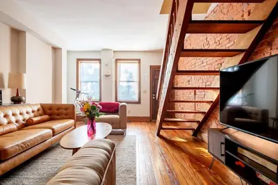 a living room with a couch and a tv at Family Friendly Home in Trolley Square in Wilmington